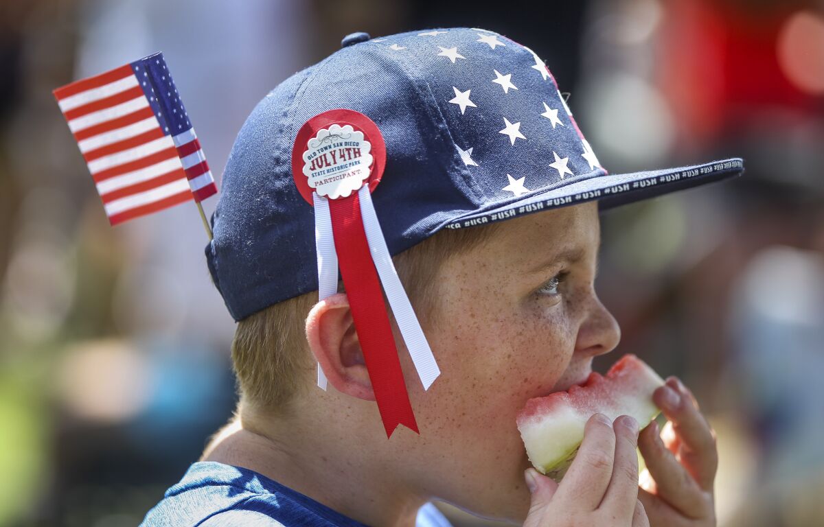 Jack Heideman, 12, visiting with his family from St. George, Utah, eats watermelon during the Old Town 1800's July Fourth celebration at Old Town San Diego State Historic Park.