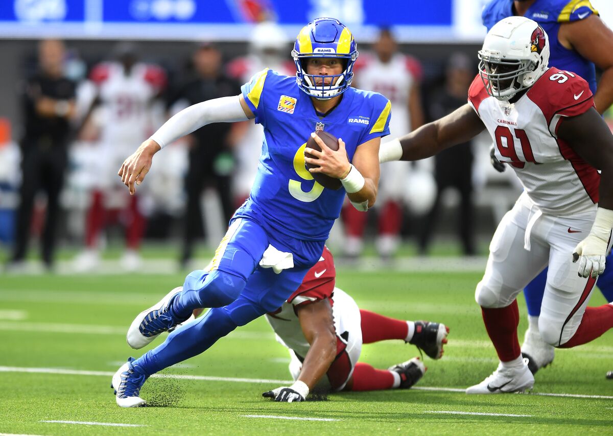 Rams quarterback Matthew Stafford scrambles for a first down against the Cardinals on Oct. 3.