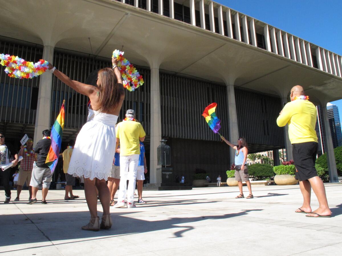 Supporters of gay marriage rally outside the Hawaii Capitol in Honolulu ahead of a Senate vote on whether to legalize same-sex marriage.