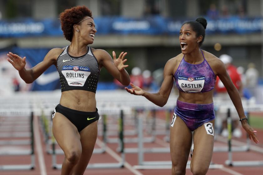 Brianna Rollins, left, celebrates her win with second-place finisher Kristi Castlin during the final of the women's 100-meter hurdles at the U.S Olympic track and field trials on July 8.