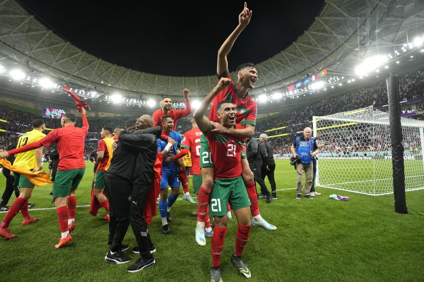 Morocco's players celebrate after winning the World Cup quarterfinal soccer match between Morocco and Portugal, at Al Thumama Stadium in Doha, Qatar, Saturday, Dec. 10, 2022. (AP Photo/Martin Meissner)