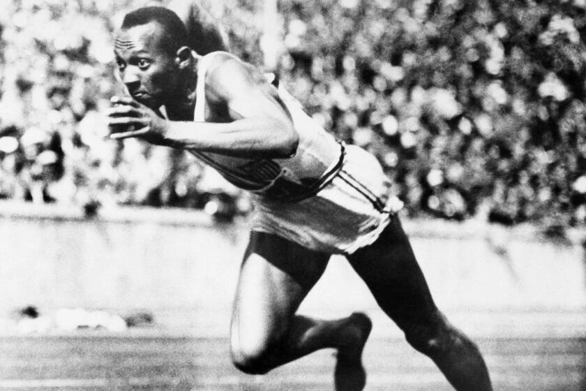 FILE -- In this Aug. 14, 1936, file photo, Jesse Owens competes in one of the heats of the 200-meter run at the 1936 Olympic Games in Berlin. Owens is the American track star who defied Adolf Hitler, winning the 100 meters, 200, 4x100 relay and long jump at the racially charged Berlins Olympics in 1936. (AP Photo/File)