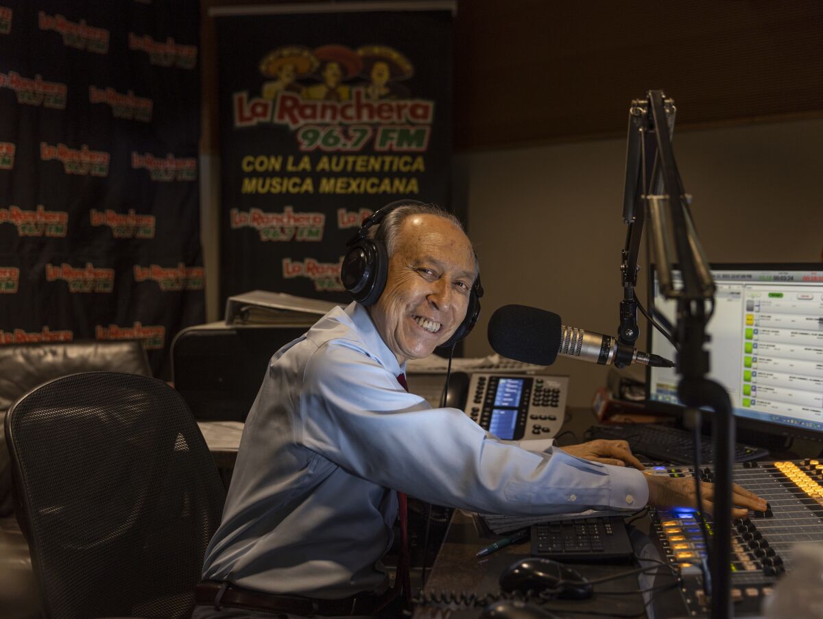 Radio host Rubén Miranda sits behind the controls.