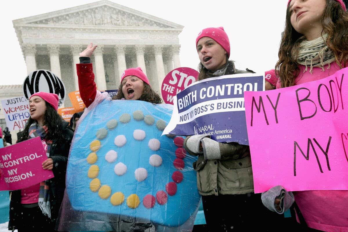 Demonstrators rally outside of the U.S. Supreme Court during oral arguments in Sebelius vs. Hobby Lobby on Tuesday in Washington.