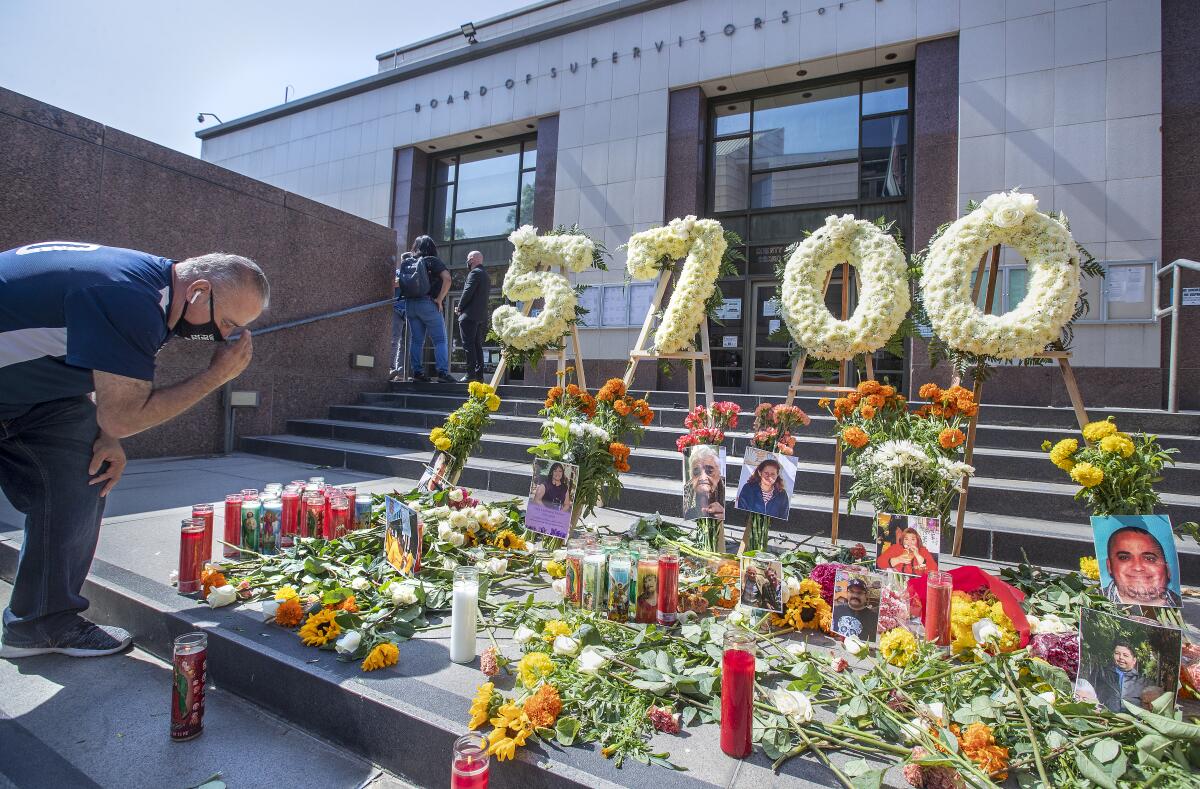  Armando Espinoza, a representative of United Food and Commercial Workers Union Local 770, visits a COVID-19 memorial.