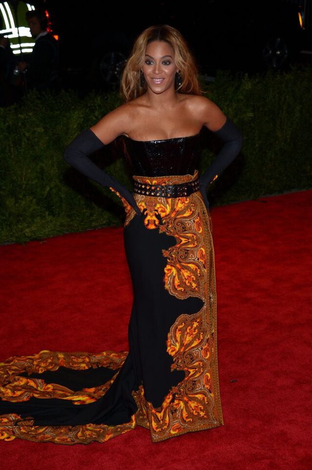 Beyonce Knowles wearing a Givenchy dress and carrying an Edie Parker clutch.