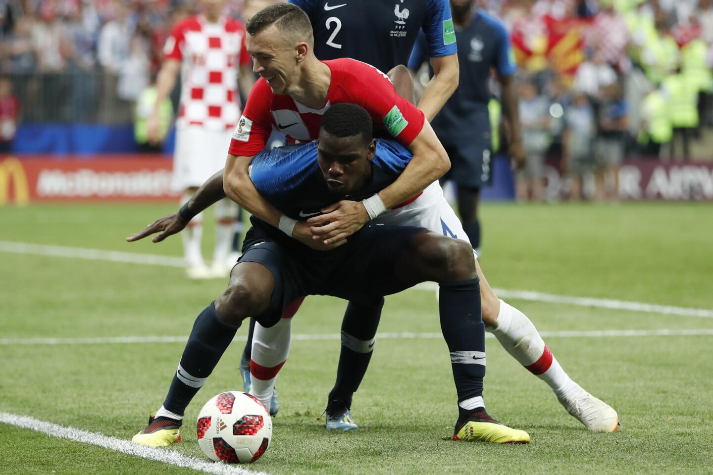 Croatia's Ivan Perisic and France's Paul Pogba battle for the ball during the final match between France and Croatia at the 2018 soccer World Cup in the Luzhniki Stadium in Moscow, Russia, Sunday, July 15, 2018.