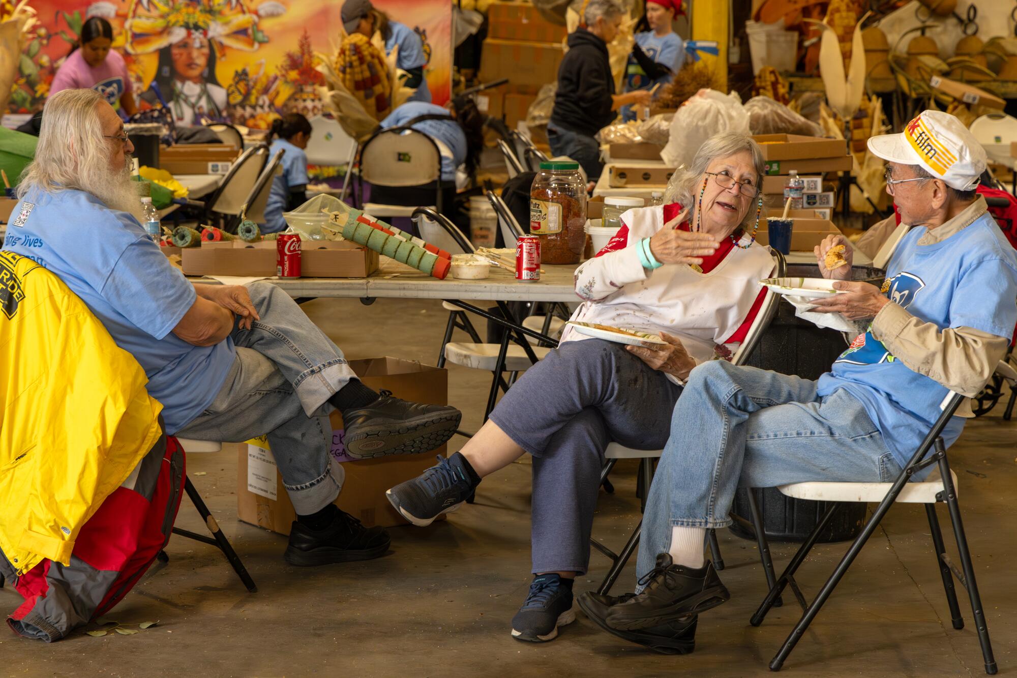 Rose Parade float volunteers chat during a lunch break in Irwindale.