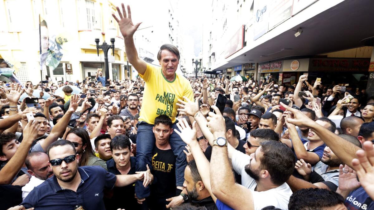 Presidential candidate Jair Bolsonaro rides on the shoulders of a supporter moments before being stabbed during a campaign rally in Juiz de Fora, Brazil, on Sept. 6, 2018.