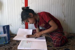 Doaa al-Hassan, 10 years old, who lost her hand to a cluster bomb in 2022, studies at a camp near the town of Ain Sheeb, northern Idlib province, Syria, on July 18, 2023. More than 300 people were killed by cluster munitions in Ukraine in 2022, according to an international watchdog, displacing Syria as the country with the highest number of deaths from the controversial weapons for the first time in a decade. (AP Photo/Omar Albam)