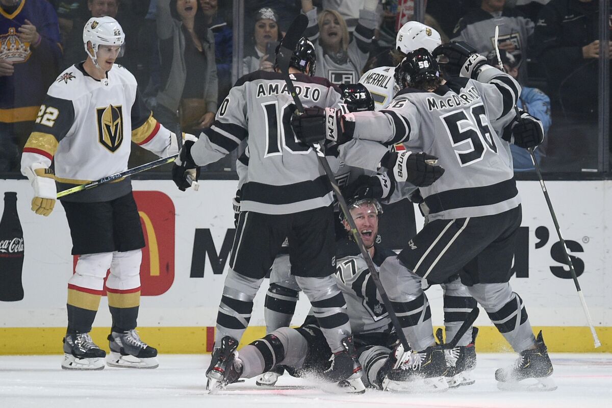 Kings players celebrate with teammate Jeff Carter, bottom, after his third-period goal.
