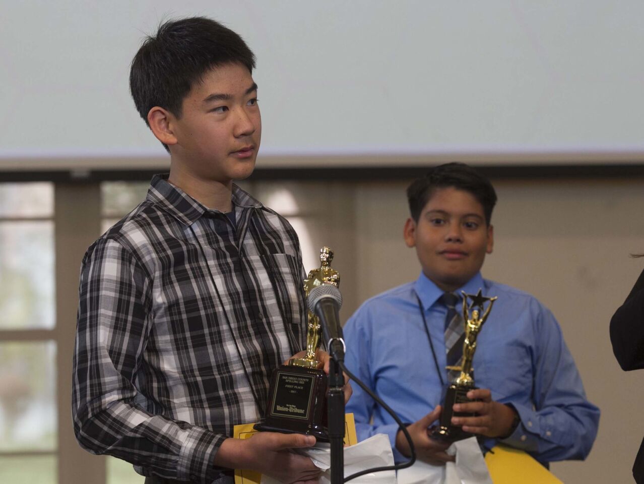 The winner of the 49th annual San Diego Union-Tribune county wide spelling bee was Kevin Luo, 13, an eighth grader from Pacific Trails Middle School, who won the by spelling the word "gradine" correct. Gradine means "one of a series of low steps or seats raised one above another." held at Liberty Station. In the background is Felipe Contreras from Pacific Beach Middle School who won second place.