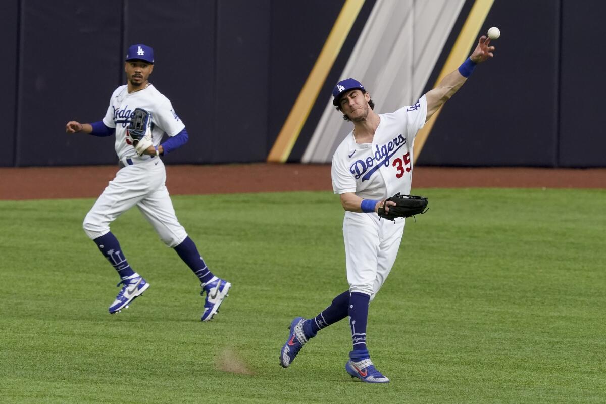 Dodgers center fielder Cody Bellinger throws after fielding a ball hit by Atlanta's Dansby Swanson.