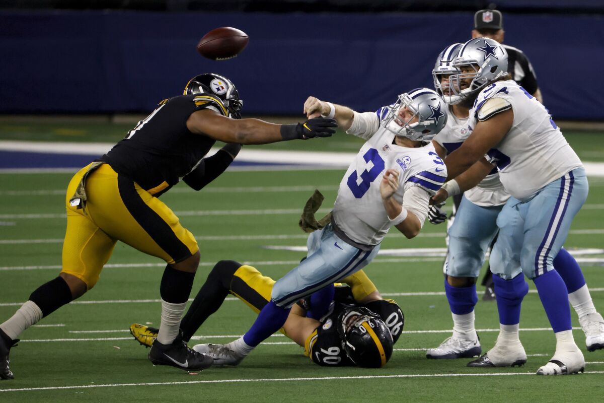Pittsburgh Steelers' Stephon Tuitt, left, and linebacker T.J. Watt (90) pressure Dallas Cowboys quarterback Garrett Gilbert (3) who throws a pass to Ezekiel Elliott (21) as center Joe Looney (73) and guard Connor Williams, right rear, look on during the play in the second half of an NFL football game in Arlington, Texas, Sunday, Nov. 8, 2020. (AP Photo/Ron Jenkins)