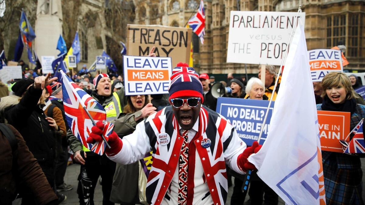 A pro-Brexit activist dressed in Union flag-themed clothes and sunglasses demonstrates opposite the Houses of Parliament in London on Tuesday.