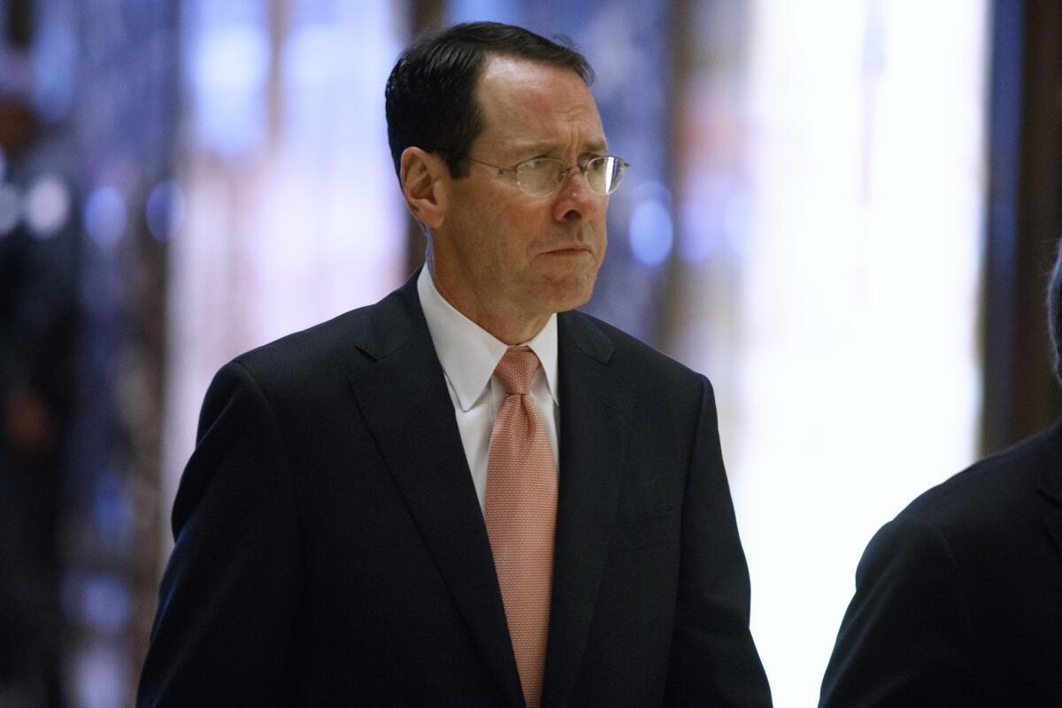 AT&T Inc. Chief Executive Randall Stephenson arrives in the lobby of Trump Tower in New York on Thursday for a meeting with President-elect Donald Trump.