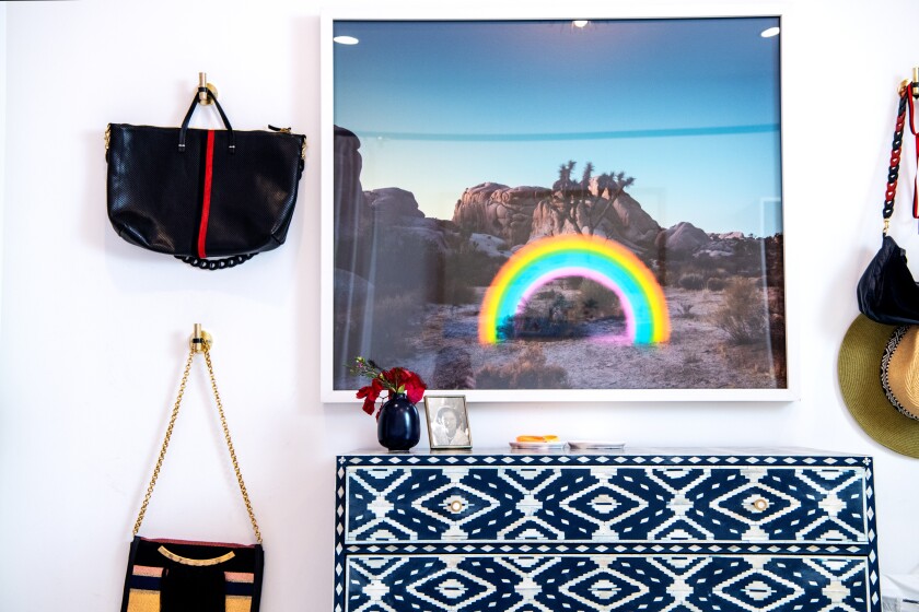 Bags hang on a wall in the master bedroom.