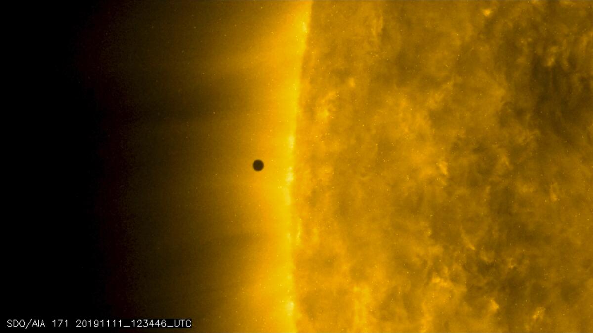 Mercury skips across sun's vast glare in rare transit - Los ...