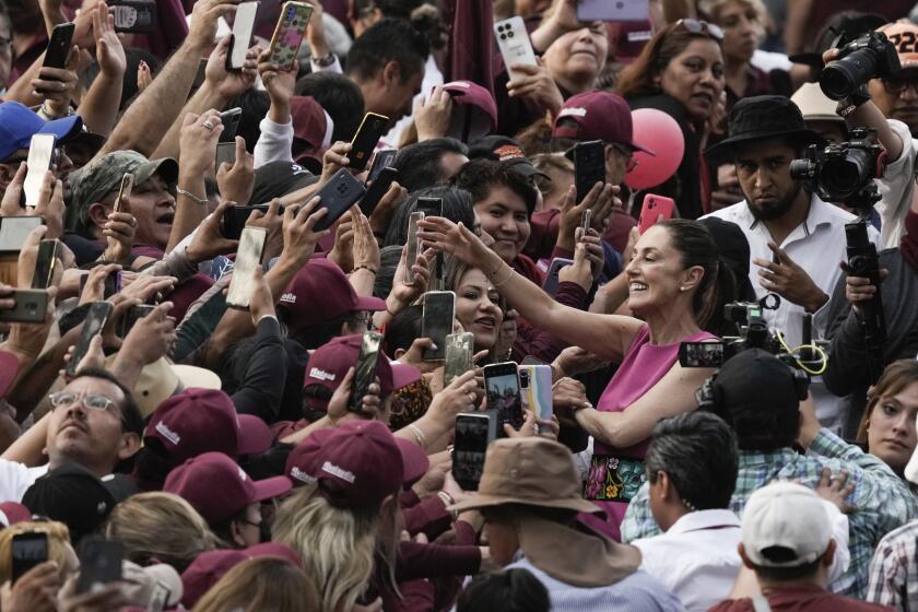 Mexico City Mayor Claudia Sheinbaum, right, greets supporters as she leaves a rally at the Revolution Monument in Mexico City, Thursday, June 15, 2023. Sheinbaum announced that she is resigning her post as Mexico City Mayor to enter the primary race for the country's 2024 presidential election. (AP Photo/Eduardo Verdugo)