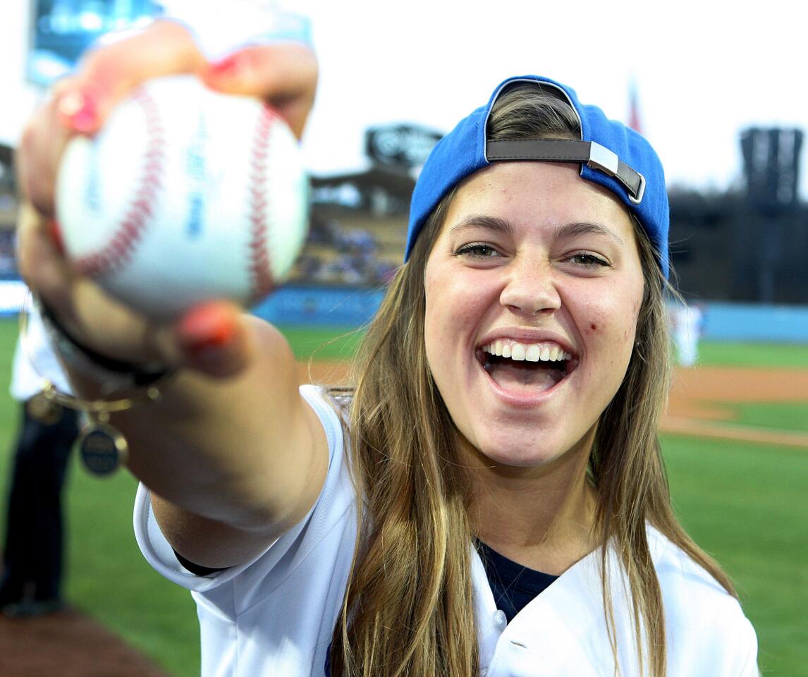 Olympian Kate Hansen, of La Canada Flintridge, happy after throwing the first pitch, shows off the baseball she threw at Dodger Stadium on Thursday, April 17, 2014. Hansen threw out the first pitch.