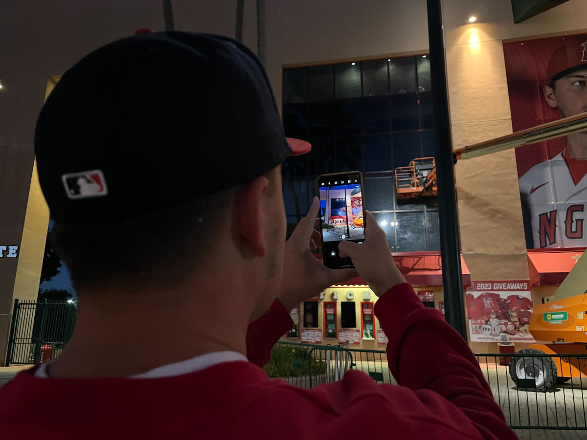 An Angels fan takes a photo of the spot where Shohei Ohtani's poster hung outside of Angel Stadium.