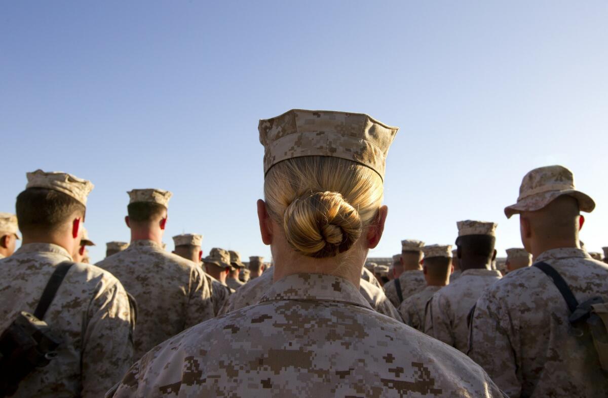 A female marine stands in formation along with her male compatriots on November 10, 2010, at Camp Delaram in Helmand province, Afghanistan. (Paula Bronstein / Getty Images)
