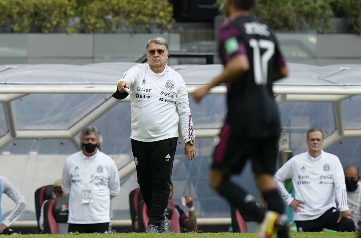 Mexico's coach Gerardo "Tata" Martino, gives directions to his players during a World Cup qualifying match
