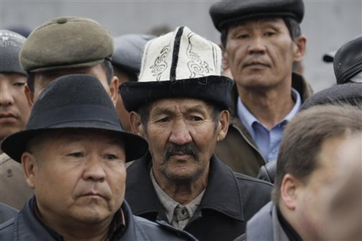Faces in the crowd, as protestors face Kyrgyz police near the main government buildings in Bishkek, Kyrgyzstan, Wednesday, April 7, 2010. Police in Kyrgyzstan opened fire on thousands of angry protesters who tried to seize the main government building amid rioting in the capital as protests spread across the Central Asian nation. (AP Photo/Ivan Sekretarev)