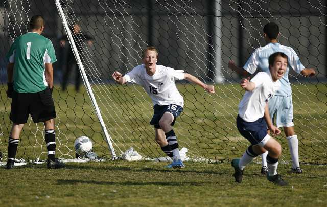 orona del Mar's Mason Case (15) and Connor Morrill (21) celebrate after Jack Gorab chipped in a shot on a penalty during a CIF Southern Section Division III second-round playoff game against Santa Ana Valley.