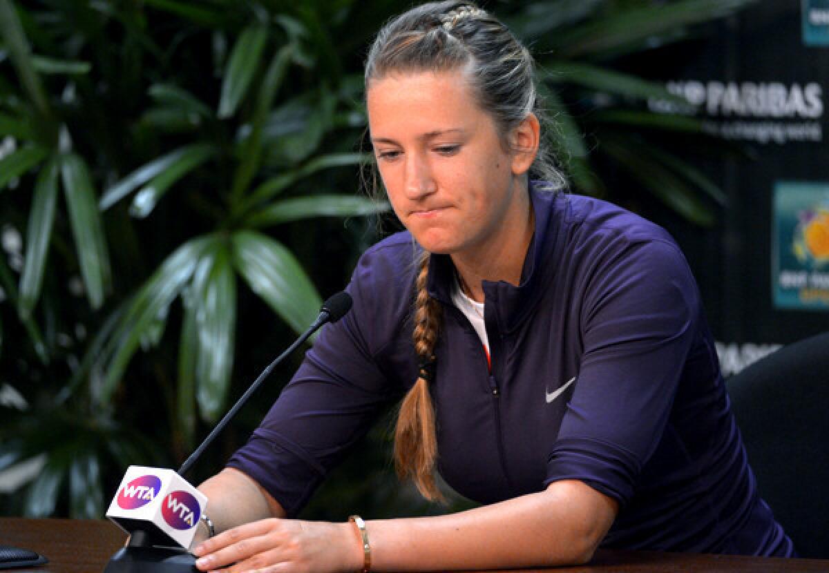 Victoria Azarenka pauses during a news conference Thursday to announce that she has withdrawn from the BNP Paribas Open tennis tournament because of an ankle injury.