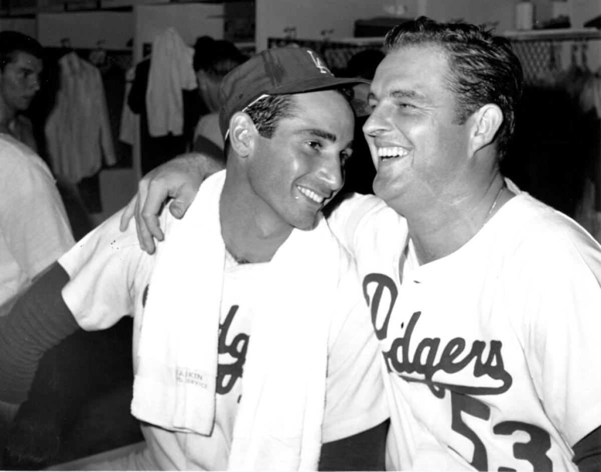 Pitchers Don Drysdale (53) and Sandy Koufax share a laugh in the locker room at Dodger Stadium
