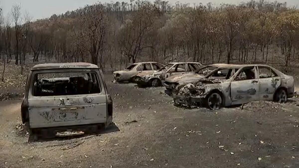An image from video shows vehicles that were charred by wildfires in Yeppoon, a town in Queensland state, Australia.