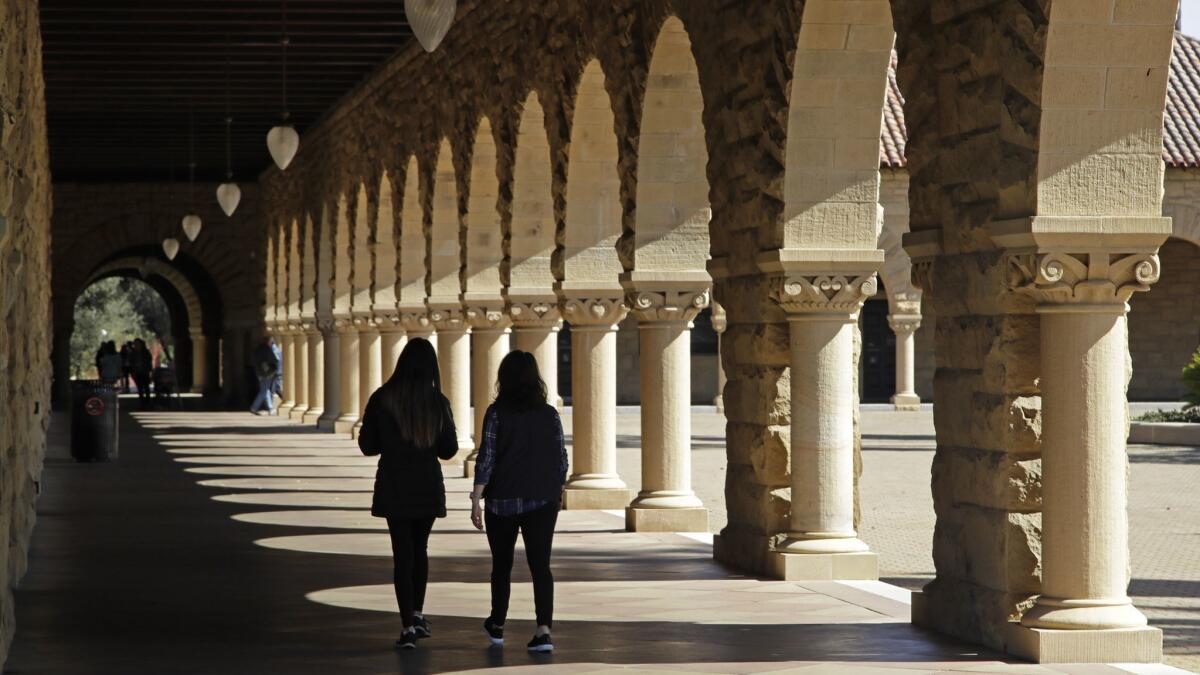 Joe Puglia writes that he advises college-bound students to consider choosing a liberal arts major such as the classics. Above, students walk on the Stanford University campus in March of this year.