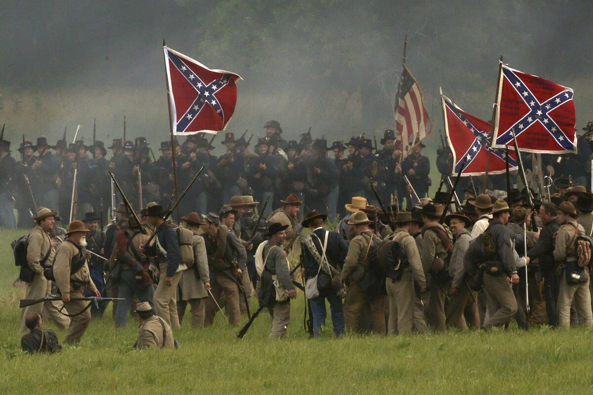 Reenactors demonstrate a battle during ongoing activities commemorating the 150th anniversary of the Battle of Gettysburg on Friday at Bushey Farm in Gettysburg, Pa.