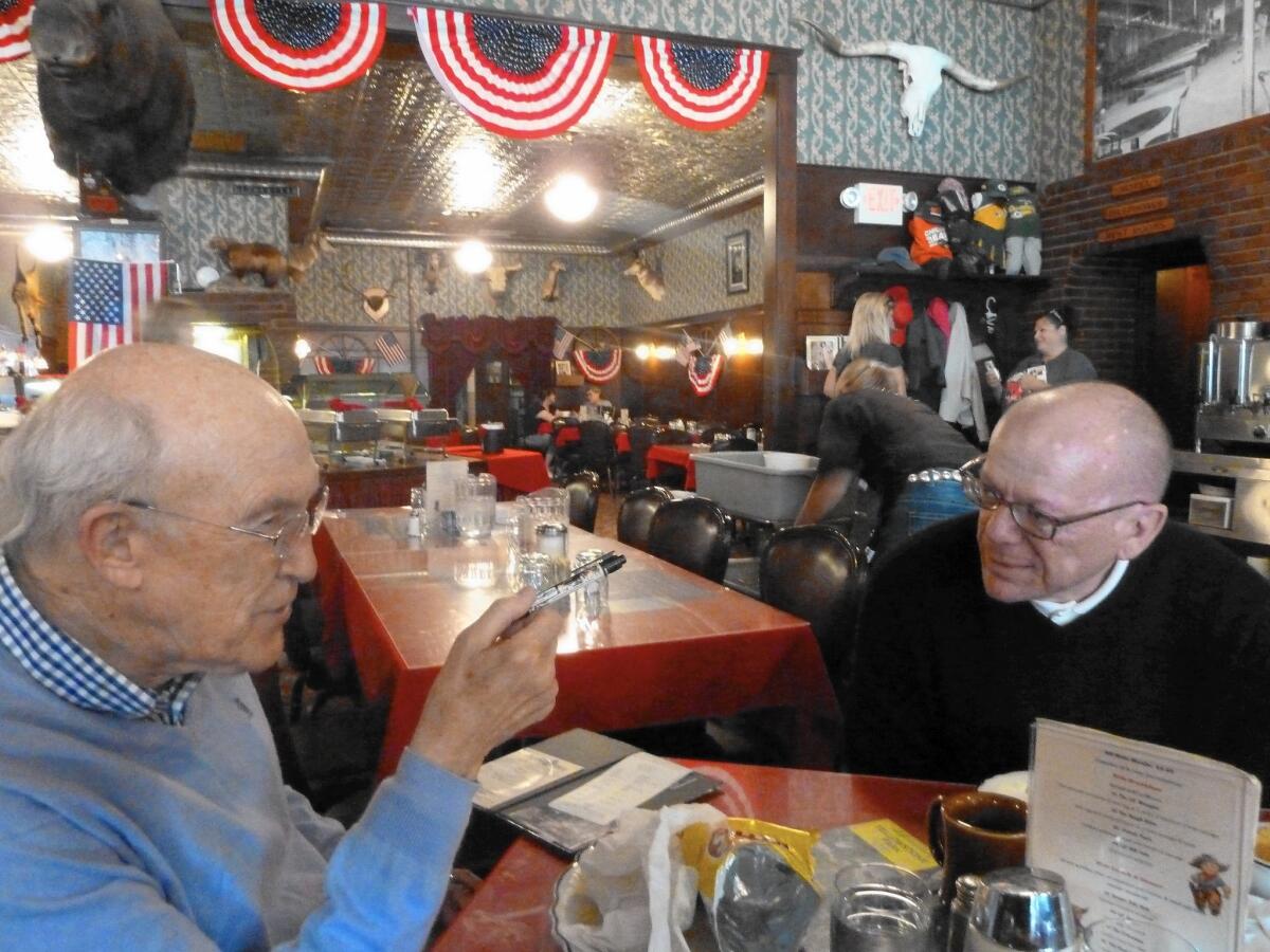 A reluctant Gregory Hinton returned to visit Wyoming after being encouraged by retired GOP Sen. Alan K. Simpson, left. Now they are friends.