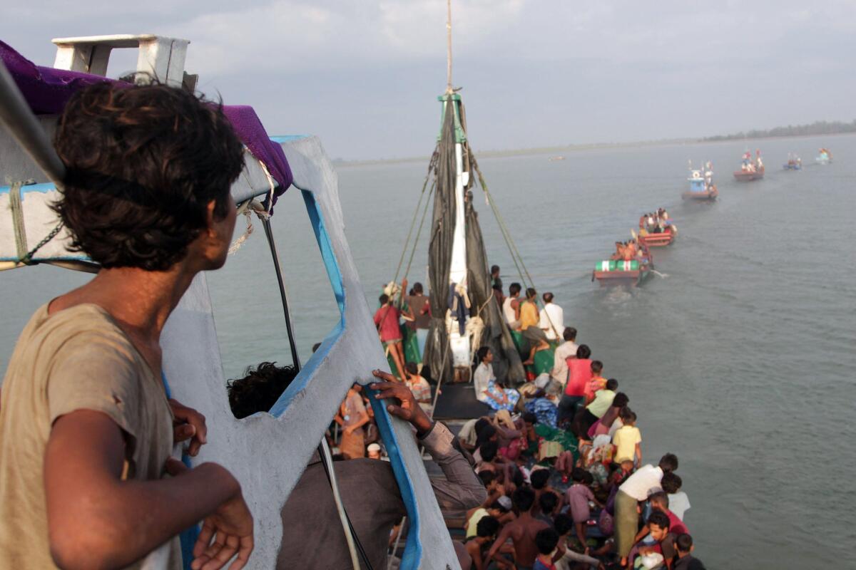 Boats of Acehnese fishermen (in front) tow a boat of Rohingya migrants in their boat off the coast near the city of Geulumpang in Indonesia's East Aceh district of Aceh province before being rescued on May 20, 2015. Hundreds of starving boatpeople were rescued off Indonesia on May 20 as Myanmar for the first time offered to help ease a regional migrant crisis blamed in part on its treatment of the ethnic Rohingya minority.