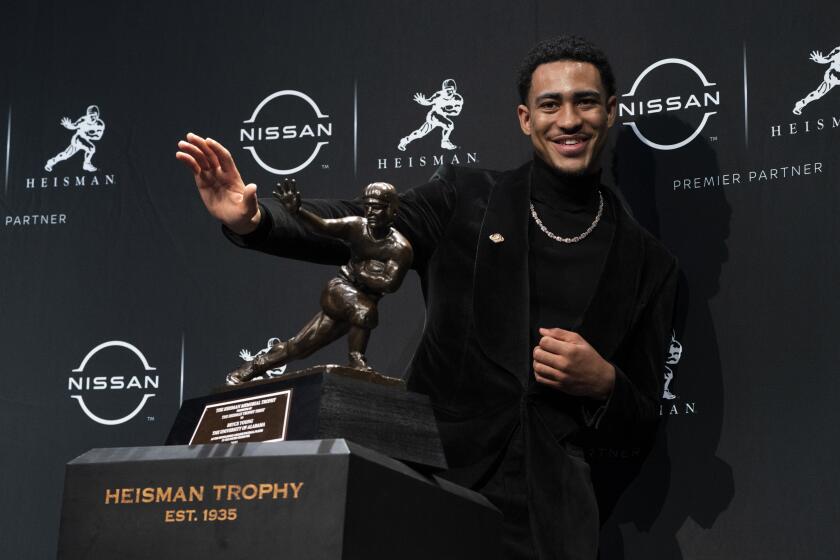 Alabama quarterback Bryce Young poses for a photograph after winning the Heisman Trophy.