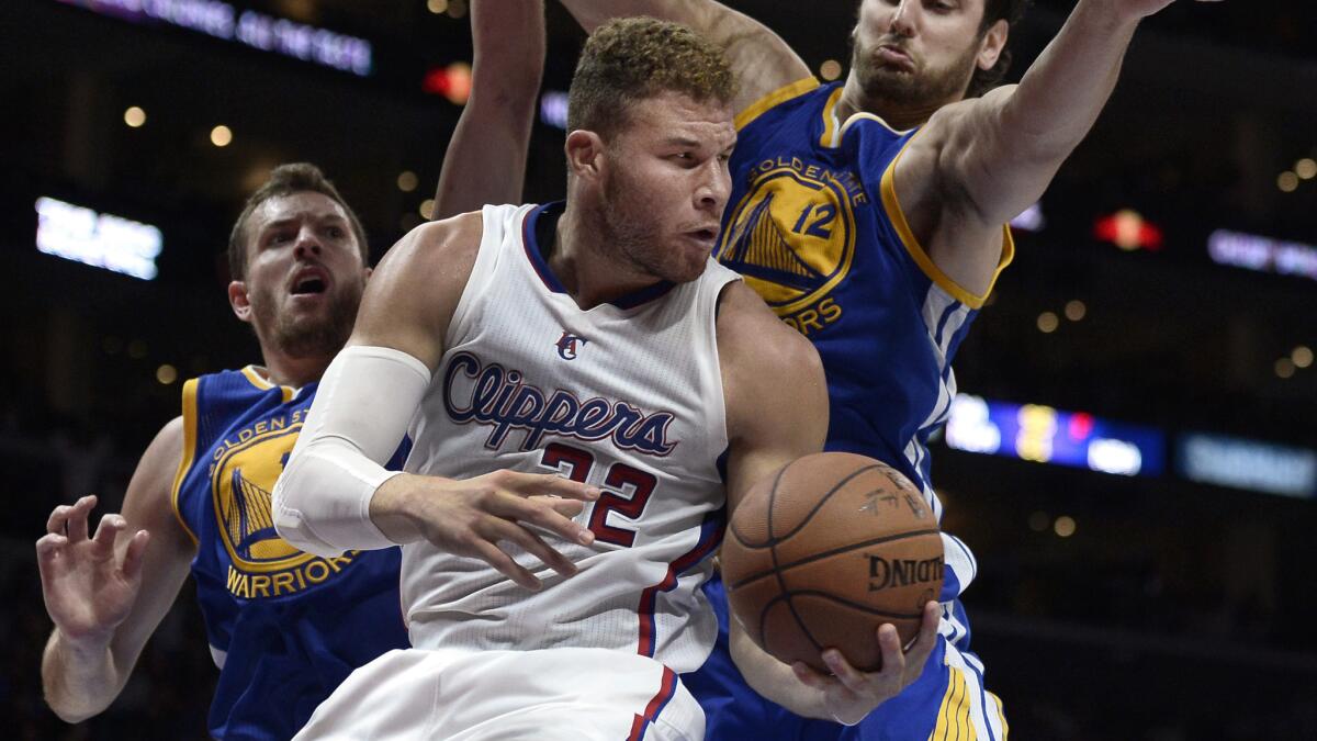 Clippers forward Blake Griffin, center, looks to pass as Golden State Warriors teammates David Lee, left, and Andrew Bogut defend during the Clippers' 110-106 loss at Staples Center on Tuesday.