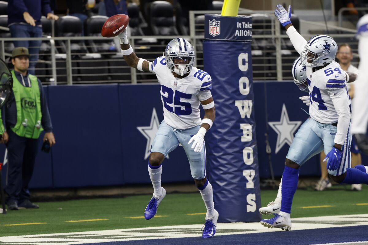 Dallas Cowboys cornerback Nahshon Wright (25) and defensive end Azur Kamara (54) celebrate after Wright recovered a blocked punt in the end zone for a touchdown in the first half of an NFL football game against the Atlanta Falcons in Arlington, Texas, Sunday, Nov. 14, 2021. (AP Photo/Ron Jenkins)