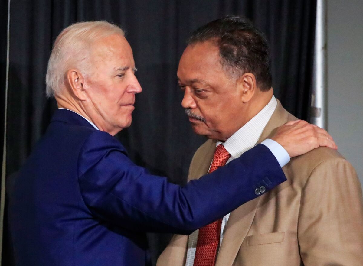 Former Vice President Joe Biden, left, with the Rev. Jesse Jackson after speaking at the Rainbow PUSH International Convention in Chicago on Friday.