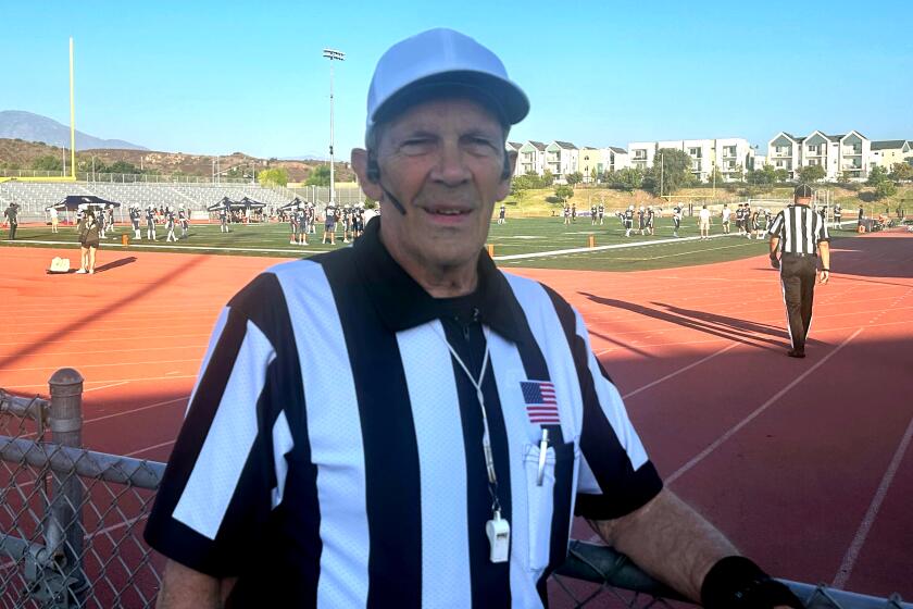 Brian Brennan poses for a photo before a high school football game.