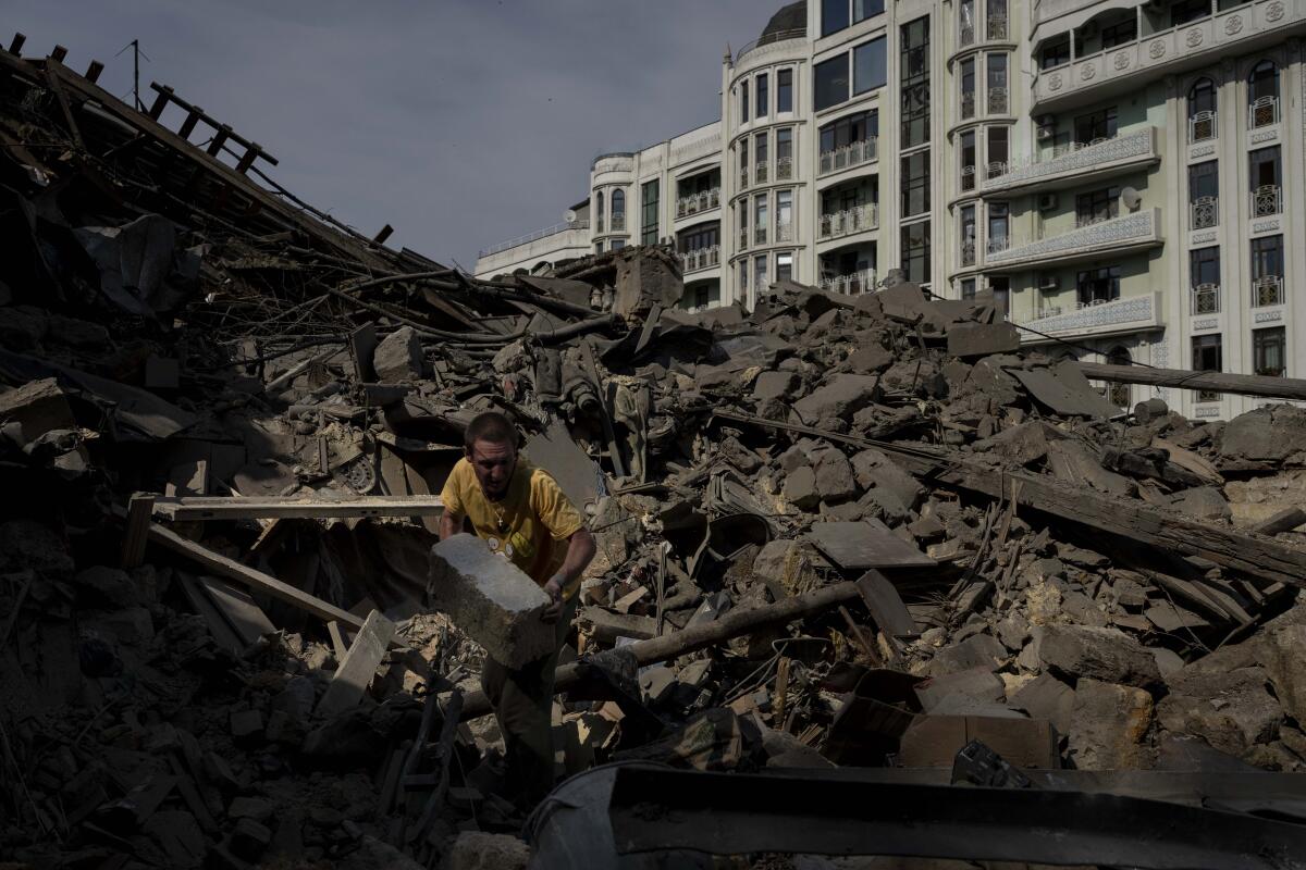 A man works on the rubble of an apartment building destroyed in Russian missile attacks in Odesa, Ukraine.