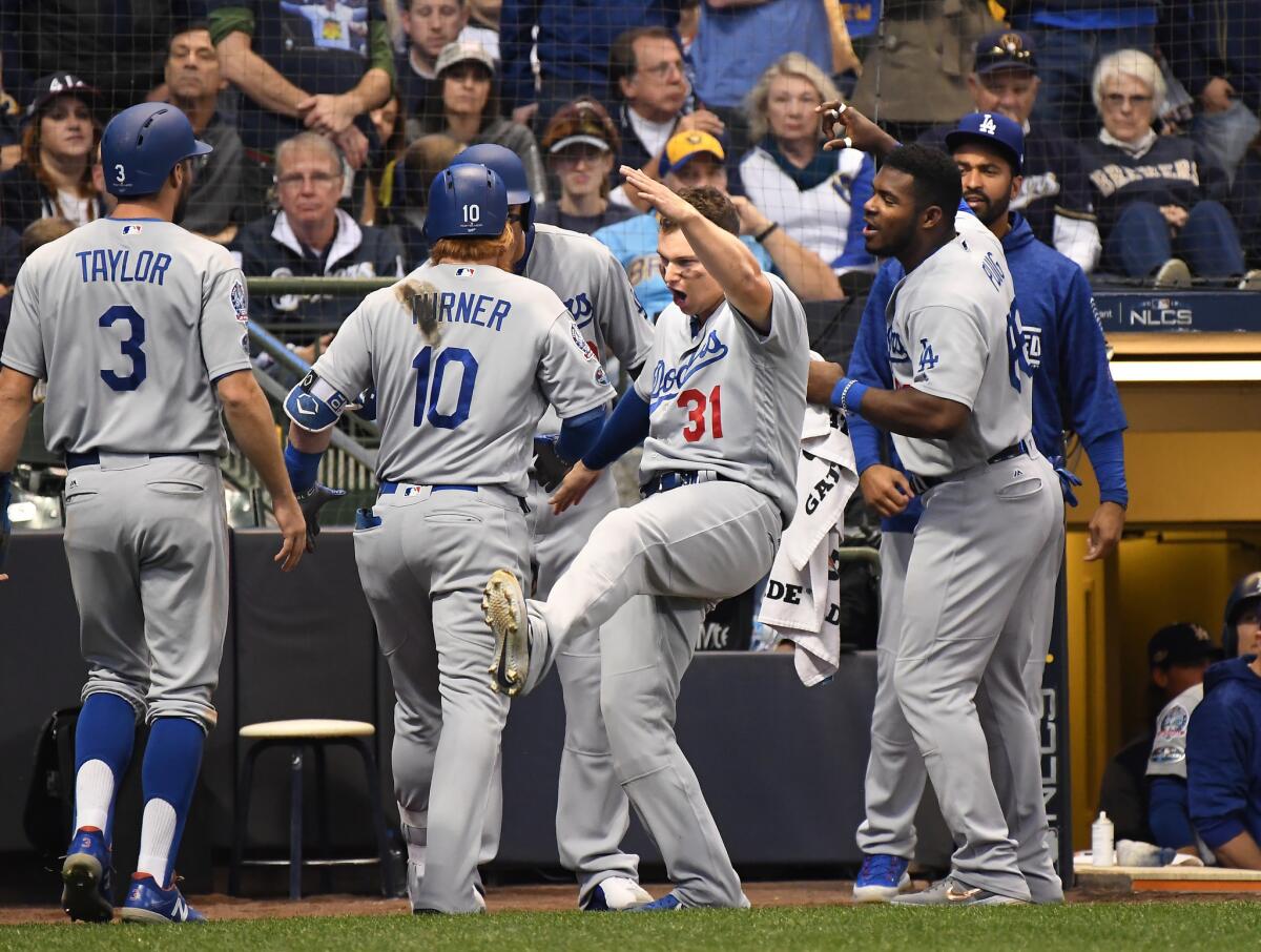 Dodgers celebrate Justin Turner's two-run home run to give the Dodgers the lead in the eighth inning in Game 2 of the NLCS at Miller Park.