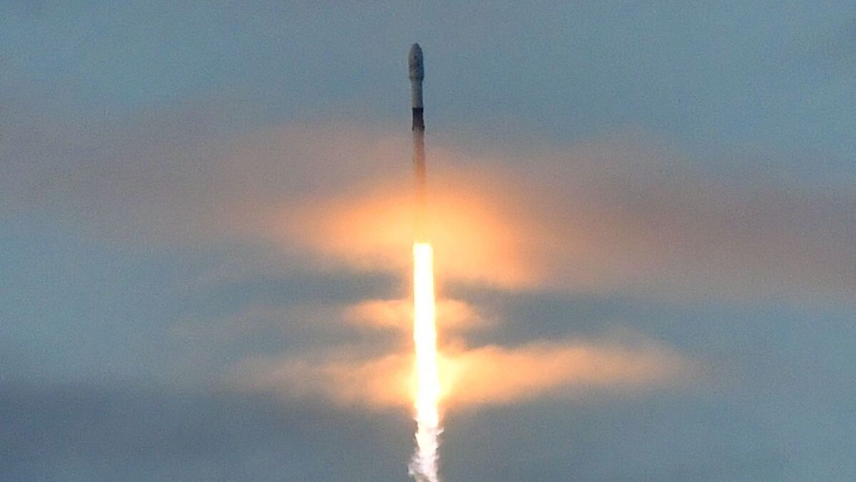 A SpaceX Falcon 9 rocket carrying 10 Iridium Communications satellites blasts off through clouds over Vandenberg Air Force Base near Lompoc, Calif., on Friday.