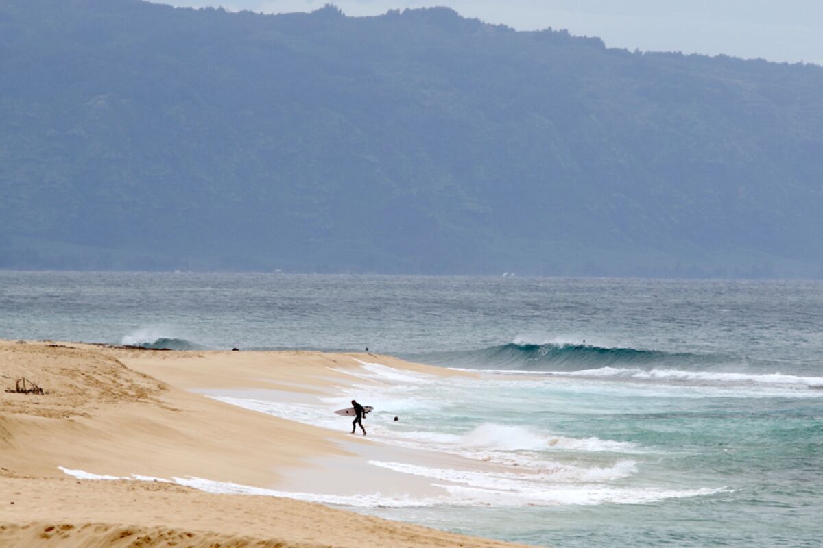 A surfer on the North Shore near Haleiwa, Hawaii.