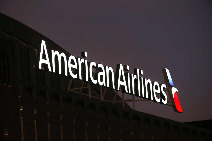 The American Airlines logo on top of the American Airlines Center in Dallas, Texas on Dec. 19, 2017. At American Airlines, revenue is higher than expected but so are costs. The airline said Tuesday, April 12, 2022 that first-quarter revenue will be a tick better than Wall Street expected. That's an indication that demand for travel has been strong and fares are rising. However, revenue is still expected to be 16% below pre-pandemic levels in 2019. And costs are rising faster than American expected just a month ago. (AP Photo/ Michael Ainsworth, file)