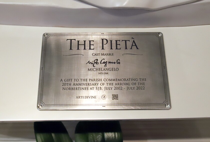 A plaque for the replica of Michelangelo's Pietà sculpture at the Catholic Church of St. John the Baptist in Costa Mesa.
