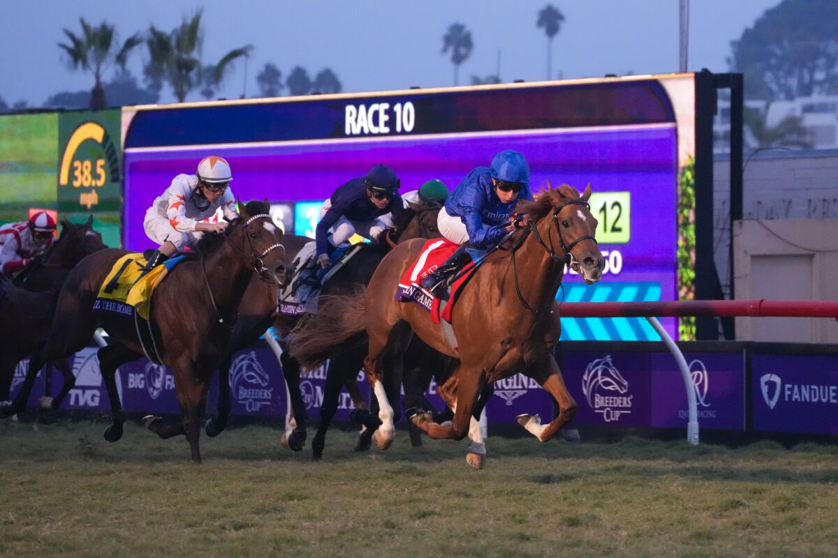 Modern Times (1) crosses the line just ahead of Tiz the Bomb (left) in the Breeders' Cup Juvenile Turf at Del Mar.