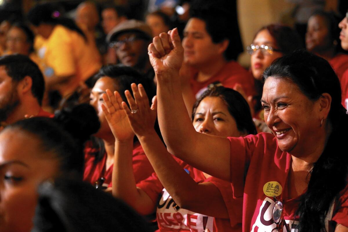 Maria Castaneda of Unite Here shows support at Los Angeles City Council meeting for raising the minimum wage.