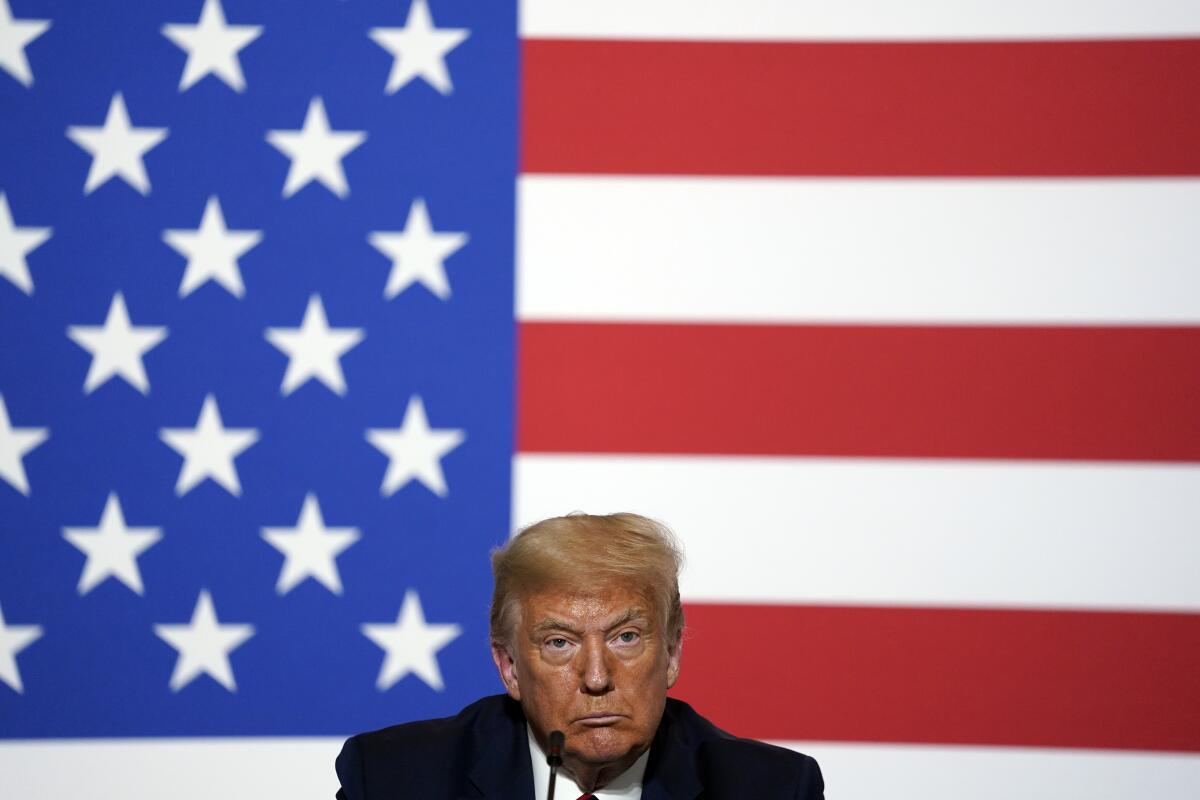 President Trump in front of a U.S. flag.